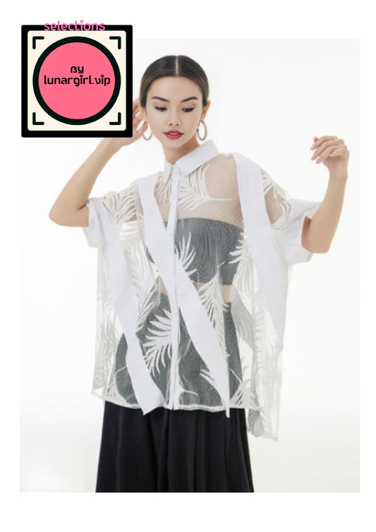 This sheer, patterned top exudes a blend of elegance and modernity. It features a combination of opaque and transparent panels, adorned with intricate leaf-like embroidery or print. The color palette is neutral, with shades of white and grey, creating a sophisticated yet versatile look. The garment has short sleeves and extends to roughly hip-length. When Worn over black undergarment, this top contrasts beautifully with its sheer elements and playful transparency.

This garment gives you that balance of fem